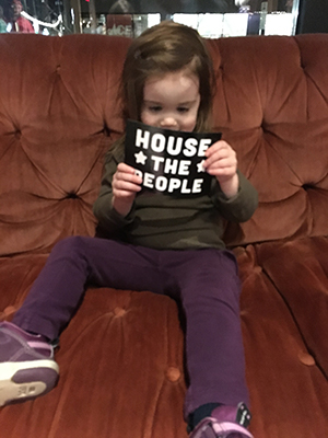 A young advocate excited about the “HOUSE THE PEOPLE” postcard campaign