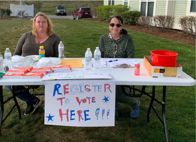 Heather Hogan (at left) and another advocate at a voter registration table