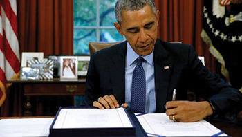 President Barack Obama signs the Housing Opportunity Through Modernization Act.