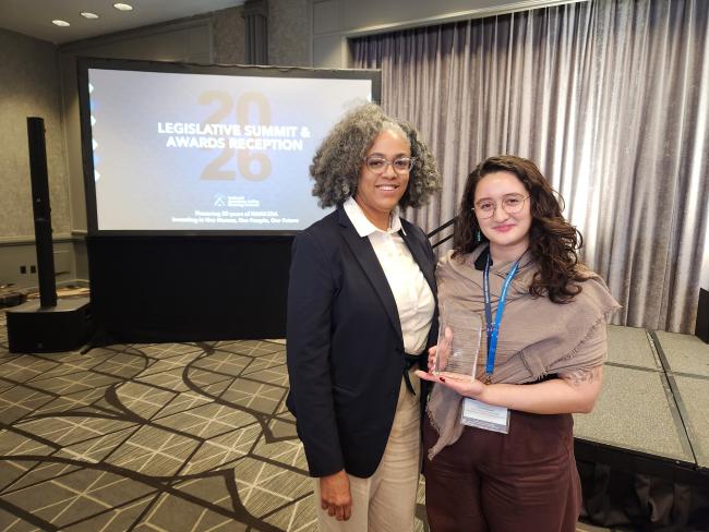 A photo of NLIHC President and CEO Renee M. Willis and NLIHC Senior Housing Policy Analyst Kayla Blackwell during the National American Indian Housing Council's 2026 Legislative Summit & Awards Reception holding an award